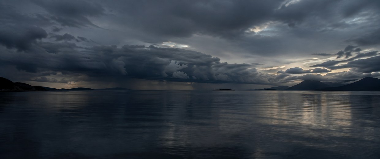 Still water under heavy storm clouds